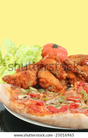 crispy chicken wings and  ham pizza with red and green peppers and salad