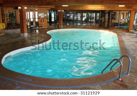 Indoor swimming pool with wood designed walls