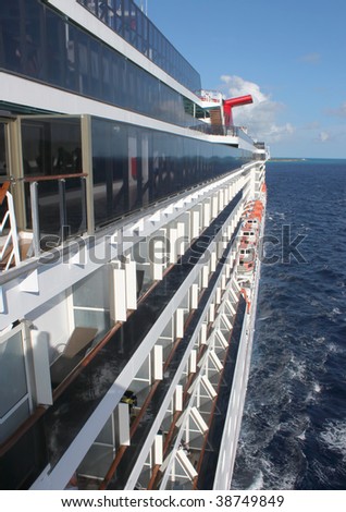 Side of cruise ship on the open seas showing balconies