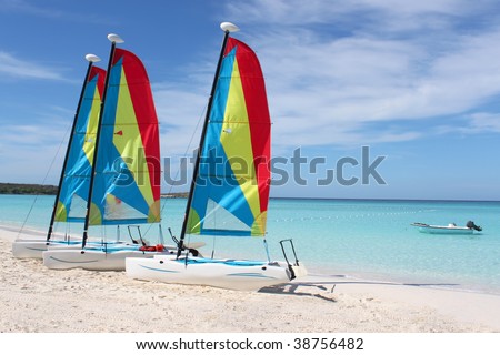 Colorful sailboats for rent on a tropical beach at Half Moon Cay in the Bahamas
