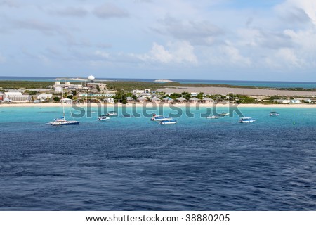 Catamarans and tour boats along the shore of a beach in Grand Turk, Bahamas islands