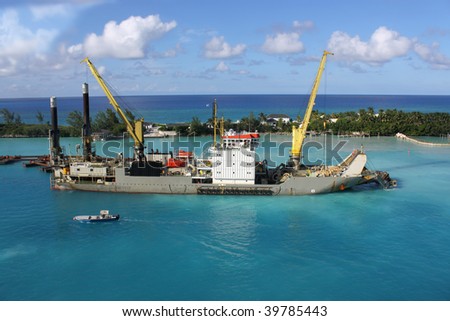 Industrial ship that digs sand making harbor deeper for bigger ships to be able to dock in Nassau port in the Bahamas