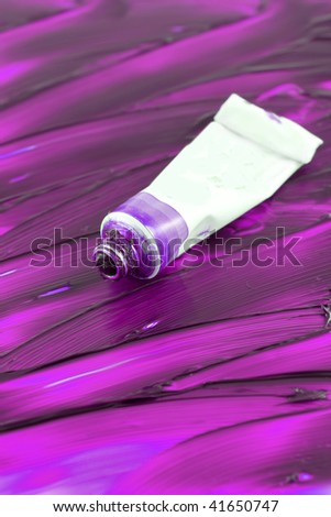 Pink, purple artist\'s oil paint tube with painted background