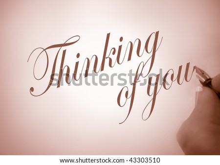 person writing thinking of you  in calligraphy in sepia tone and creative lighting