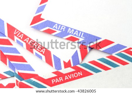 Close up of striped Air Mail envelopes  in different languages in red and blue