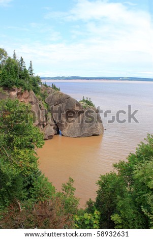 Muddy water with the high tide overlooking some of the landscape at Hopewell Rocks, New Brunswick, Canada