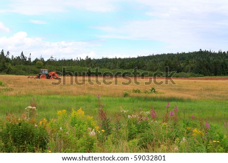 Colorful rural farmland scene with red tractor in New Brunswick, Canada