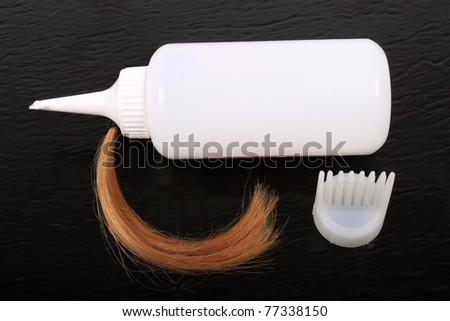 stock photo : Blonde hair lock and application tip and bottle for coloring