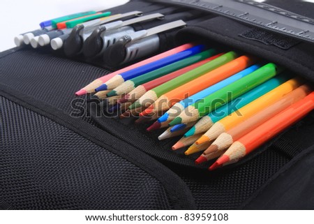 Colorful sharpened  pencil crayons and pens for school in organizer pockets