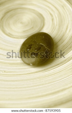 zen stone with water drops on bamboo background - sepia tones HDR
