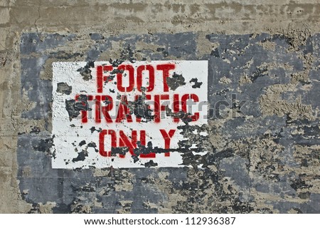 Grunge painted sign on concrete foot traffic only