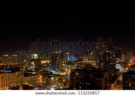 Scene of tall buildings lit at night from high up in downtown San Diego, California