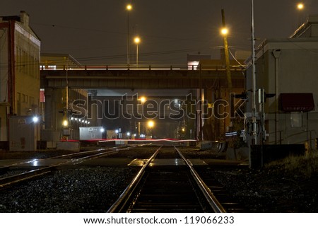 Night scene of train tracks in the rain.