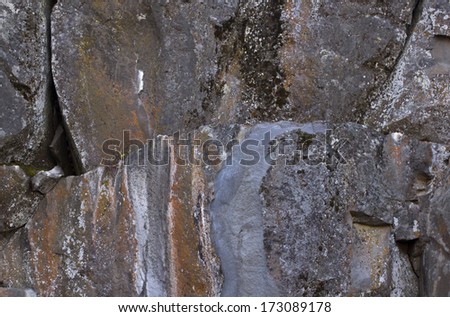Colorful lichen streaks on large rocks