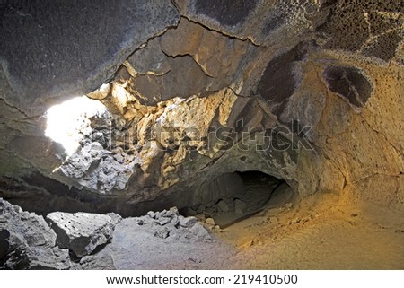 Sun beaming in skylight to interior of Sunshine Cave Lava Tube