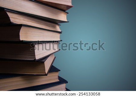Books stacking. Back to school. Blue background.
