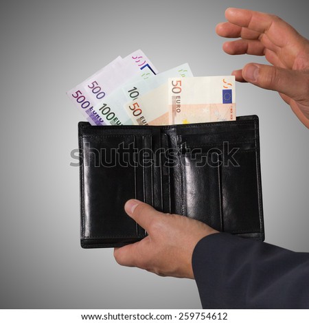 Euro banknotes isolated on a grey background. Man counts money euro. Man hides money in his wallet.