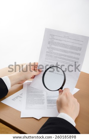 Signing papers. Lawyer, realtor, businessman sign documents, looking through the magnifying glass, search information.