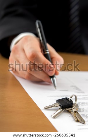 Signing papers. Lawyer, realtor, businessman sign documents.