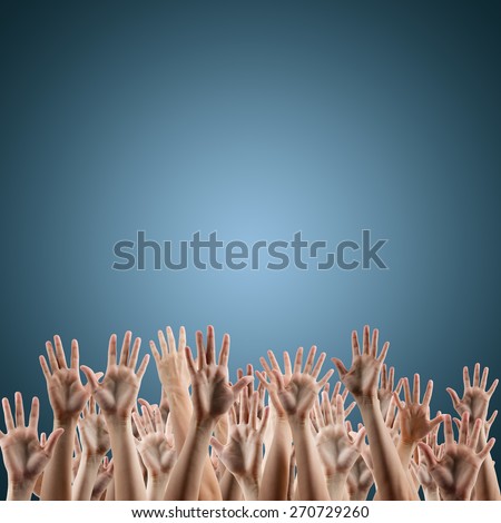 Many people\'s hands up isolated on blue gradient background. Various hands lifted up in the air. Clipping path. Copy space.