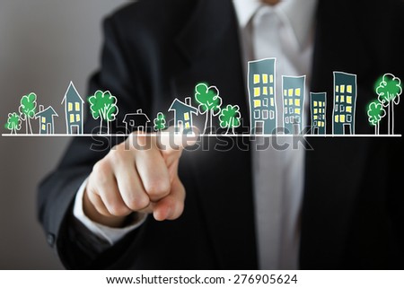 Businessman choosing house, real estate concept. Hand pressing the house icon. Copy space.