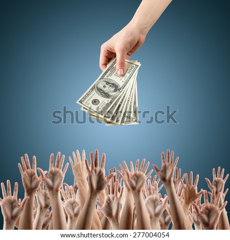 Female hand holding money dollars offering them many hands reaching out for earning money. Rich and poor concept. Competition in the labor job market. Line for unemployment benefits Blue background