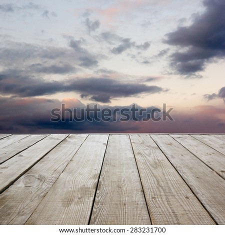 Wooden perspective floor with planks on sky background, can use for display or montage your products template. Copy space