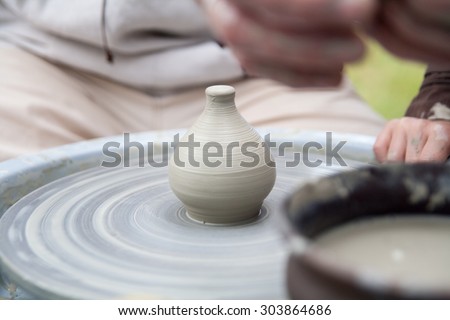 Pottery. Hand made ware. Hands working on pottery wheel. Potter working at his workshop