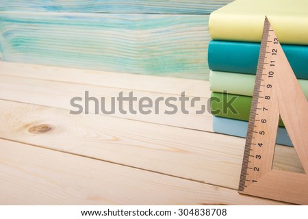 Back to school. Stack of colorful books on wooden table. Composition with vintage old hardback books, diary on wooden deck table. Books stacking. Copy Space. Education background.