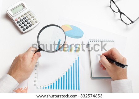 Businessman counting losses and profit working with statistics, analyzing financial the results.