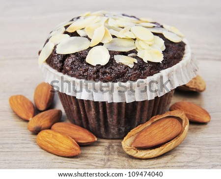 Almonds cake with almonds nuts on wooden texture