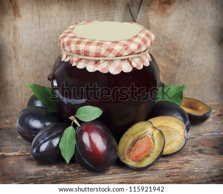 Jam with plums fruit on wooden texture