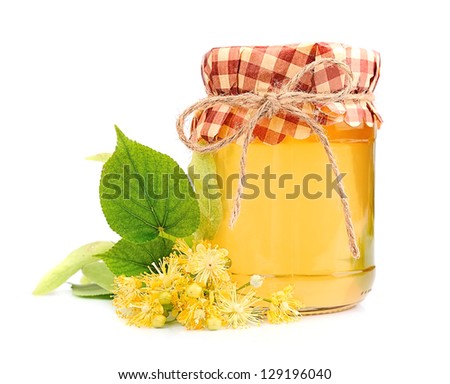 Honey with linden flowers on white closeup