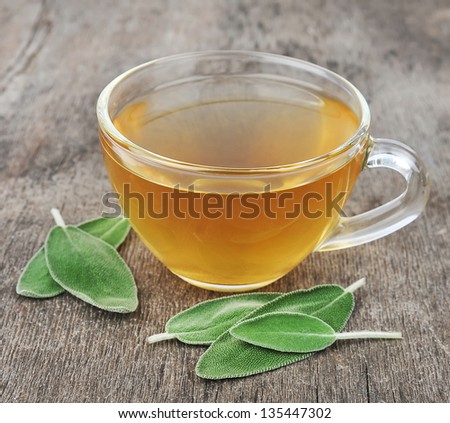 sage leaves and sage tea on wooden tables