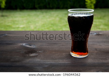 glass with drink on the table - party in the garden