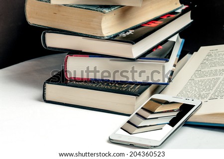 Smart phone and books demonstrating changes in technology