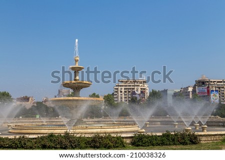 Bucharest, Romania - August 10, 2014: The water fountains in Unirii Square cool down the atmosphere on a hot summer\'s day on 10th of August 2014 in Bucharest Romania.