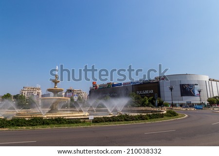 Bucharest, Romania - August 10, 2014: The water fountains in Unirii Square cool down the atmosphere on a hot summer's day on 10th of August 2014 in Bucharest Romania.