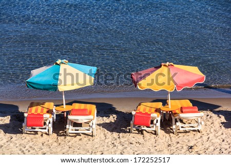 Chairs and umbrellas in calm exotic beach, Greece