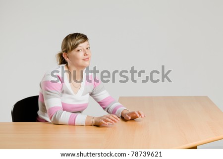 young pretty girl seated at the table