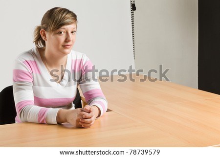young pretty girl seated at the table