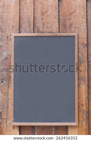 Blank chalkboard with wood paneling.