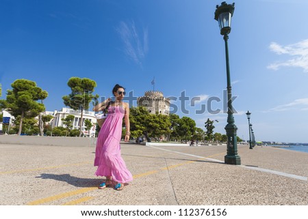 Girl posing in front of the white tower at Thessaloniki city in Greece