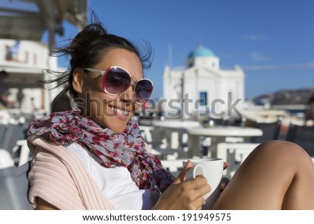 a beautiful girl drinking coffee in the Greek island of Mykonos