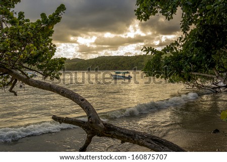 A fisherman gets ready to go to sea as the sun sets Balandra Bay North-East coast Trinidad