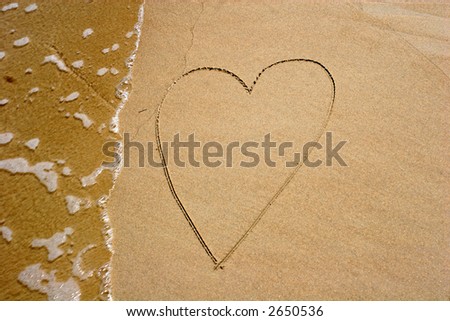 Heart in the sand-The sea washes away a heart drawn in the sand
