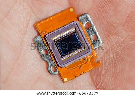 Macro Photo of an image sensor from a point and shoot digital camera in the palm of a hand