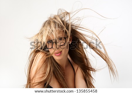 Portrait of a beautiful  woman with wonderful waving hair. Woman in glasses.