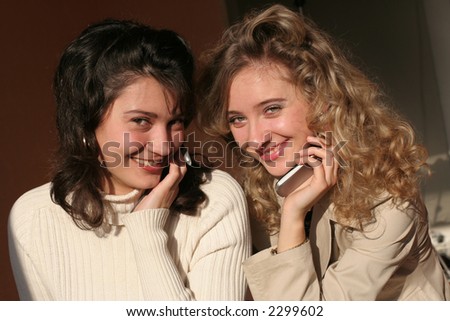 Beautiful young women  with headset and  young women  with  mobile phone.
