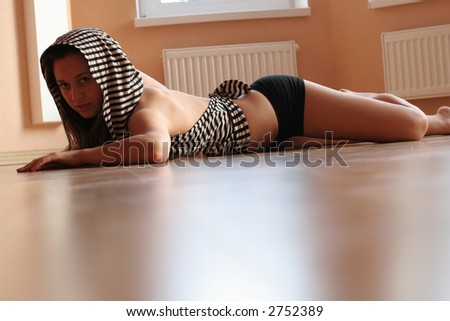 Young beautiful woman on wood floor.